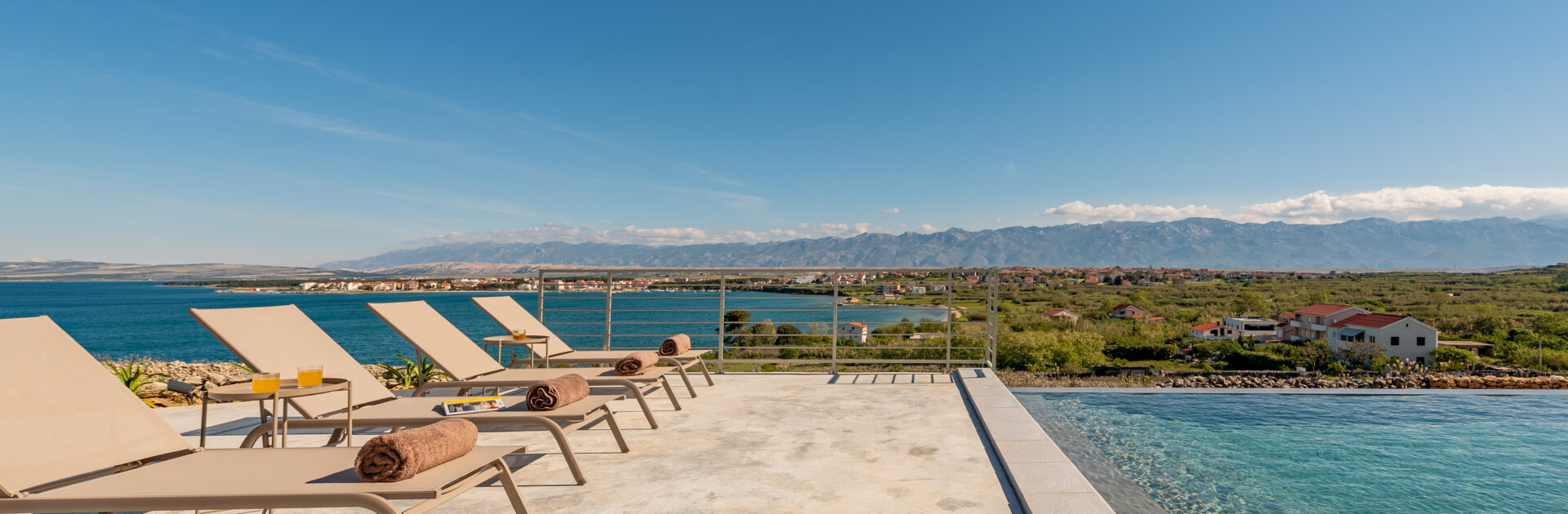 DSC7079-HDR Sun loungers by infinity pool near the coast