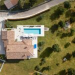 Aerial view of a private villa with pool and large garden